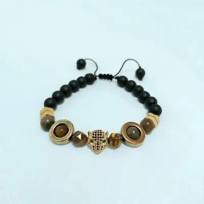 دستبند مردانه سنگ چشم ببر و حدید طلایی و سر ببرسوارسکی زیورآلات مردانه-72614